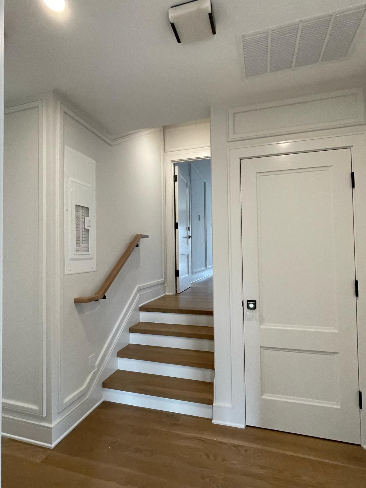 Crisp white trim & paneled stairwell landing