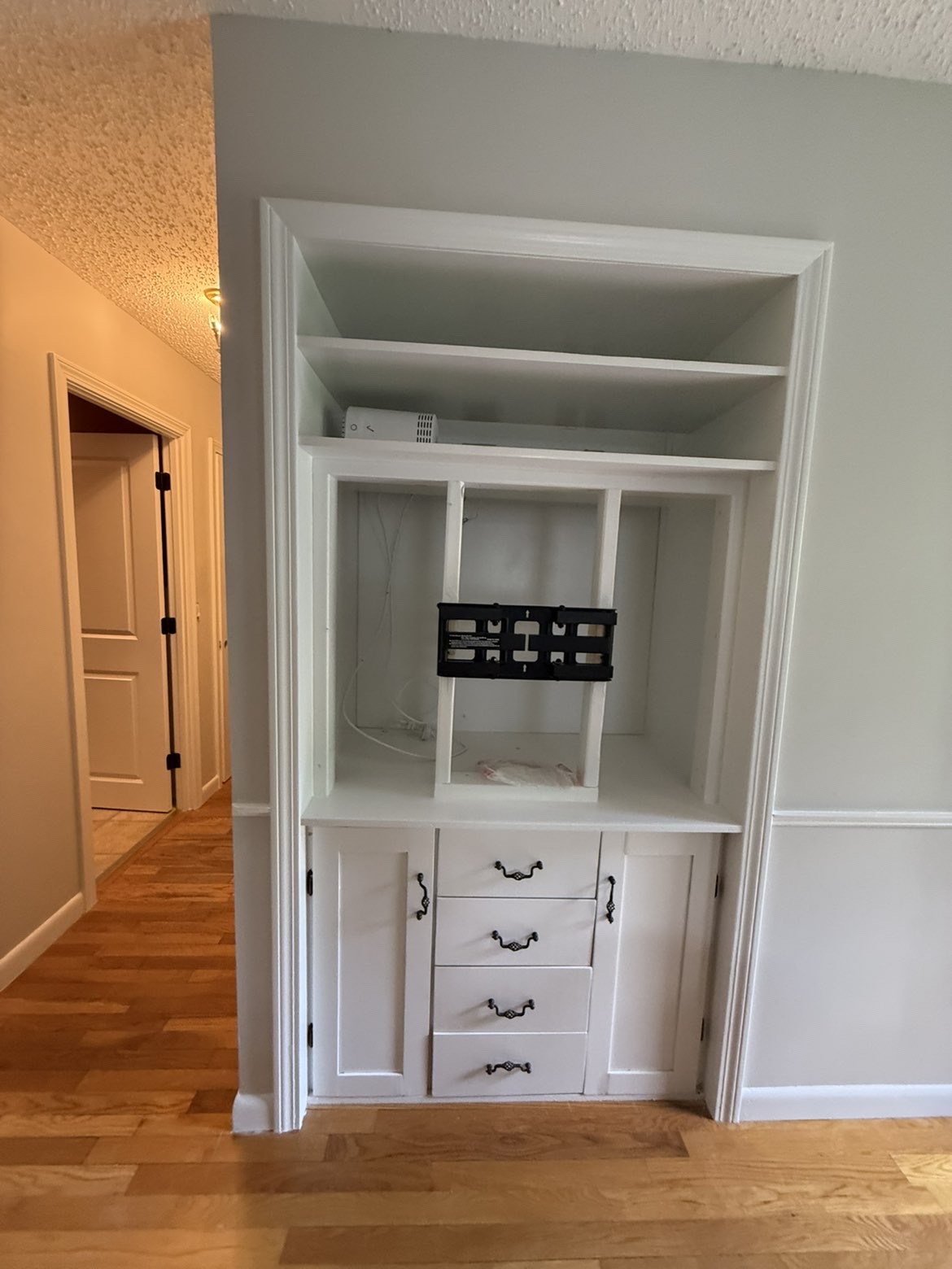 Custom built-in cabinetry & shelving repainted bright white