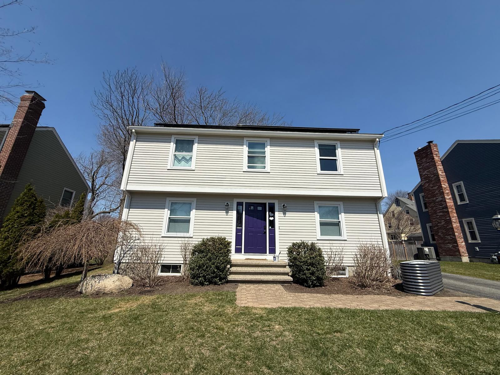 Exterior colonial repaint — crisp white siding with bold purple front door