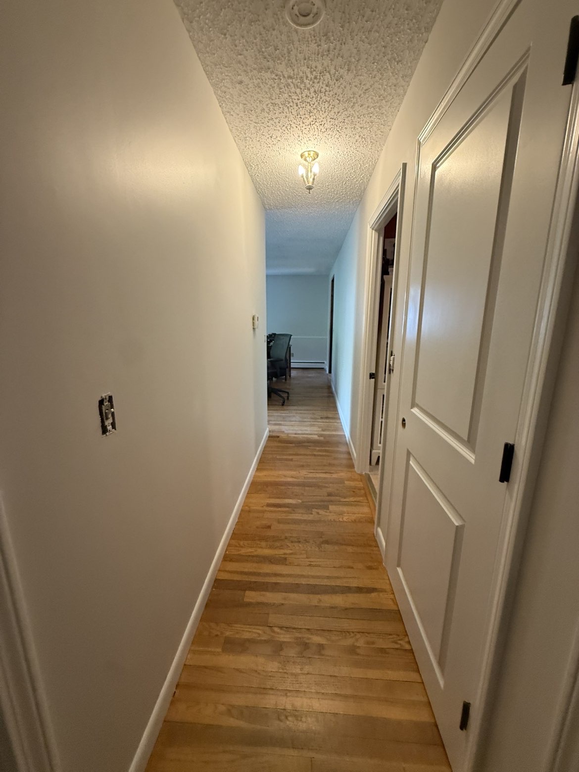 Freshly painted hallway with smooth white walls & bright trim
