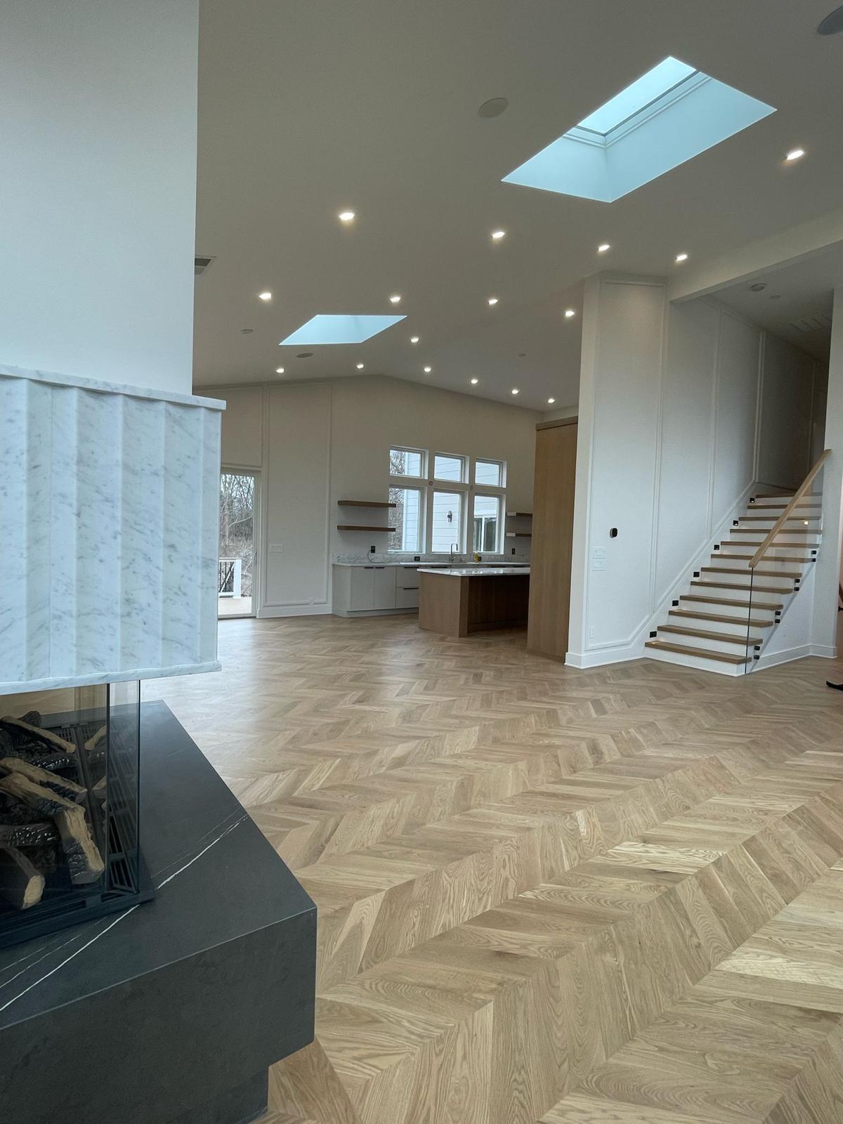 Open-concept great room with marble fireplace