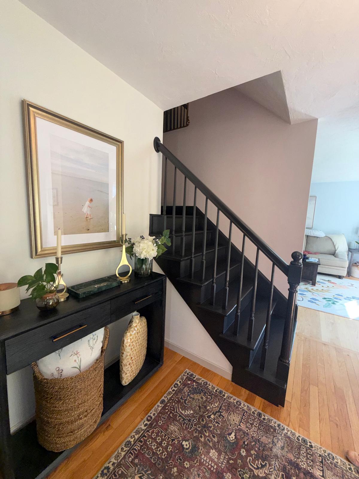 Interior entryway with hand-painted black staircase & railing