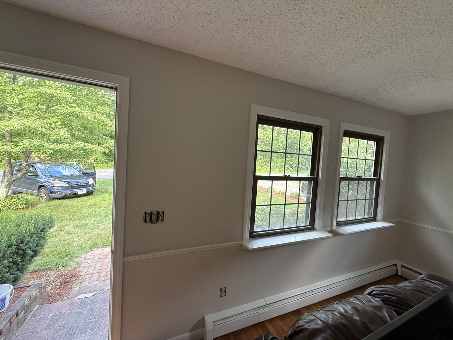 Bright living room with crisp trim & repainted window frames
